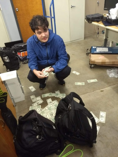 A picture of young me with a dumb look on my face and a bunch on cash on the floor